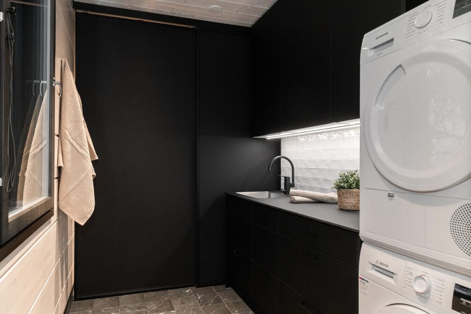 A practical utility room equipped with a washer and dryer provides everything needed for longer stays or active holidays.