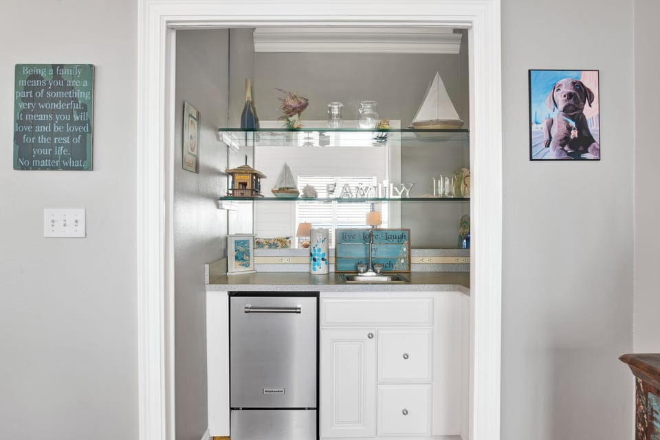 The wet-bar features a sink and standalone ice maker