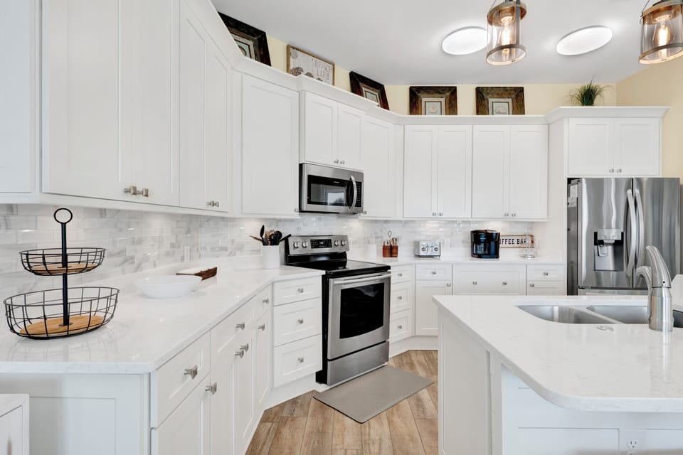 Modern kitchen with stone counter tops and stainless steel appliances