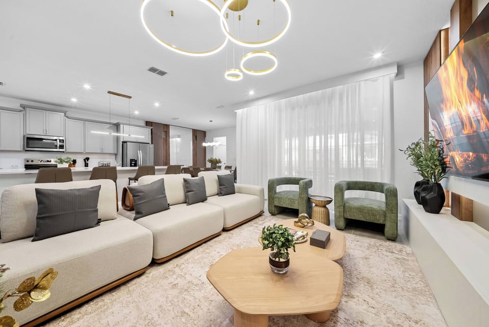 Welcome to this stylish living room, featuring a plush cream sectional and vibrant green chairs that create a playful contrast.