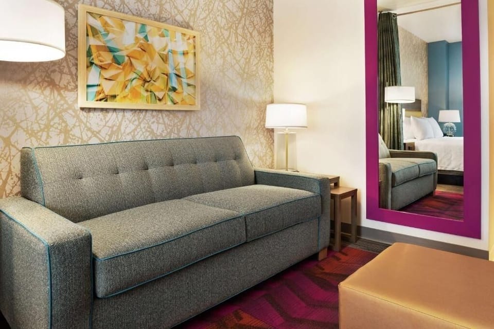 Lounge comfortably on the sofa with warm lighting and modern art