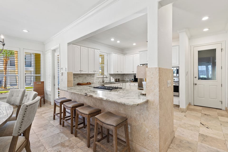 Your spacious gourmet kitchen features granite countertops, premium appliances, and a breakfast bar where you can start each morning with coffee.