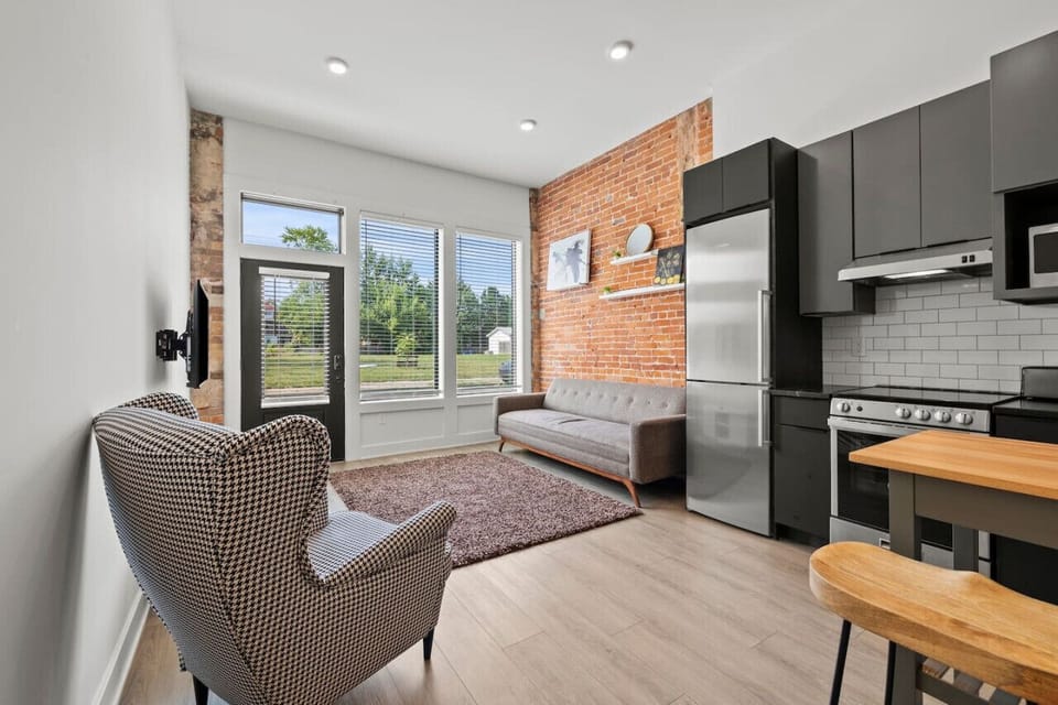 🌟 Our charming kitchen and living room, adorned with rustic brick walls, create the perfect ambiance for relaxation and culinary adventures.
