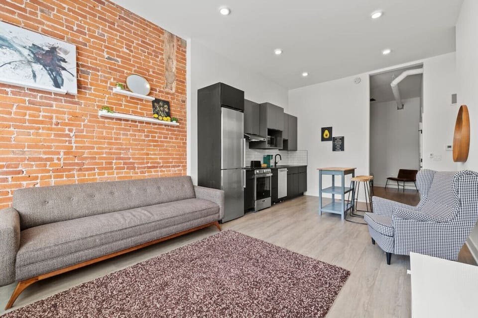 There`s something magical about a living room adorned with stylish furniture against a rustic brick wall. It`s where memories are made and laughter echoes! 🏡❤️