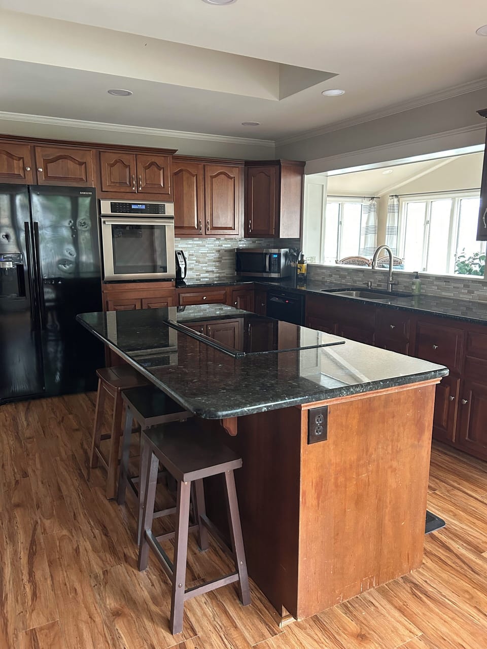Kitchen with window seat and counter height stools.  Lake Views.