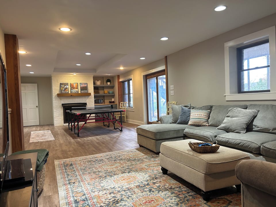 Game room and lounge area on lower floor with walkout to backyard. 