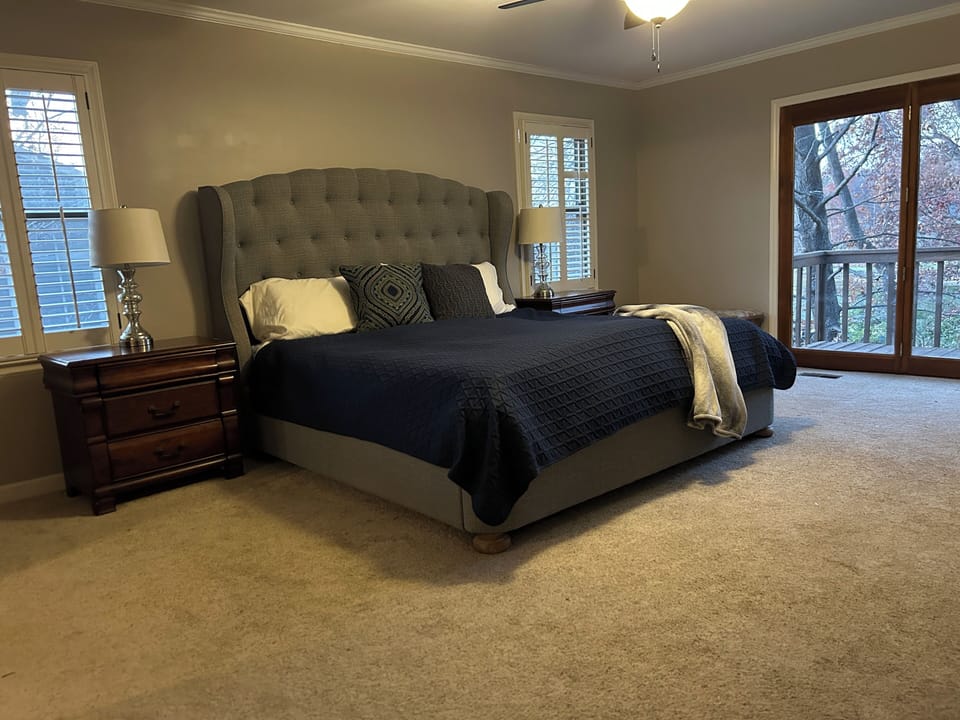 Bedroom 1: King size bedroom with en suite bathroom and lake views.