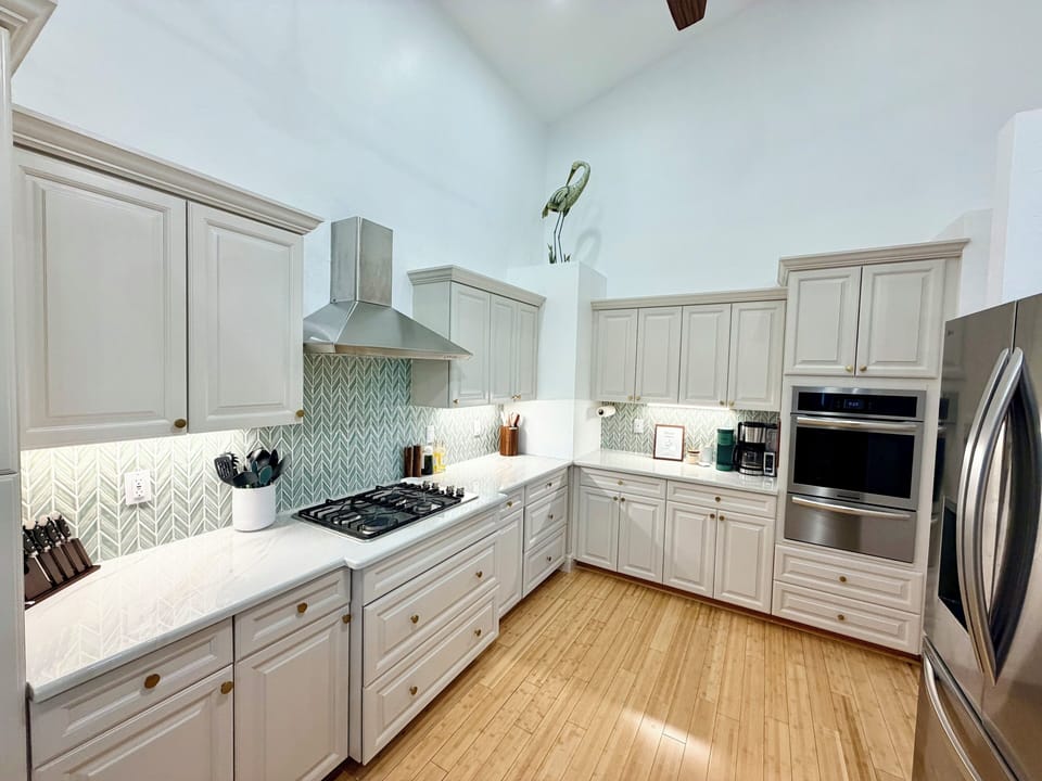 Kitchen with new oven, dishwasher & refrigerator. New backsplash and paint.