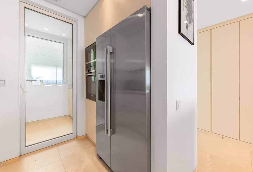 Fully equipped kitchen with modern appliances, washer and dryer.