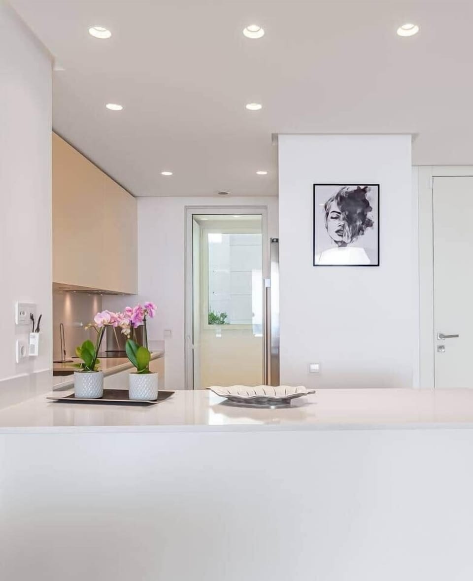 Fully equipped kitchen with modern appliances, washer and dryer.