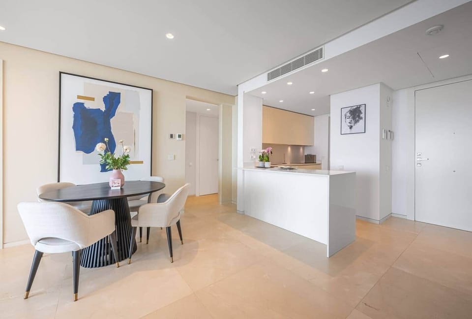 Living room with sofa, smart TV and sea-view terrace access.