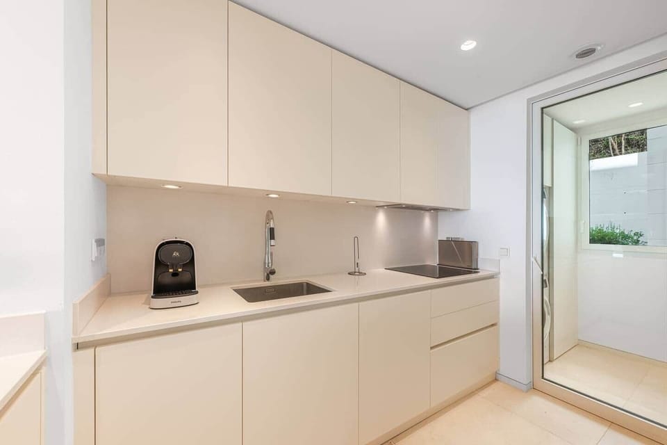 Fully equipped kitchen with modern appliances, washer and dryer.