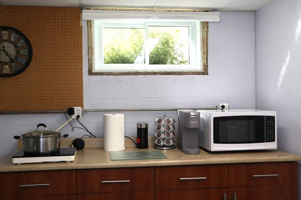 Cooking area the Induction cooktop is a one burner.   Pots are located cabinet under the microwave: Keurig coffee maker and hot/cold milk frother.  