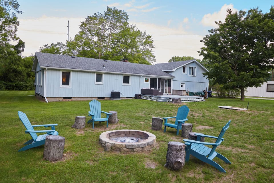 Backyard fire pit area with seating.