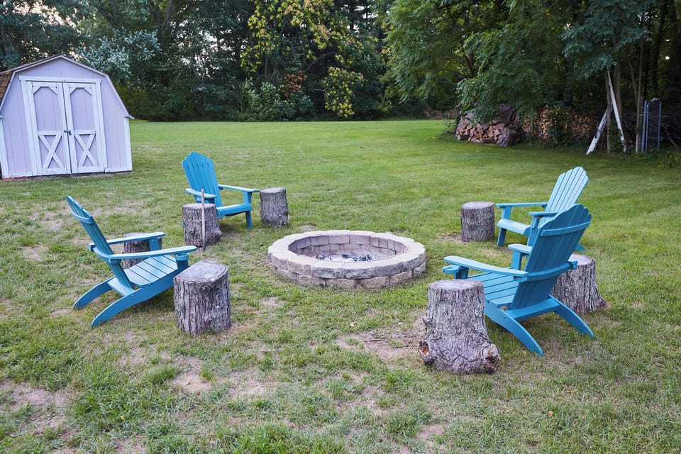 Backyard fire pit area. Grassy area for running around and playing sports.
