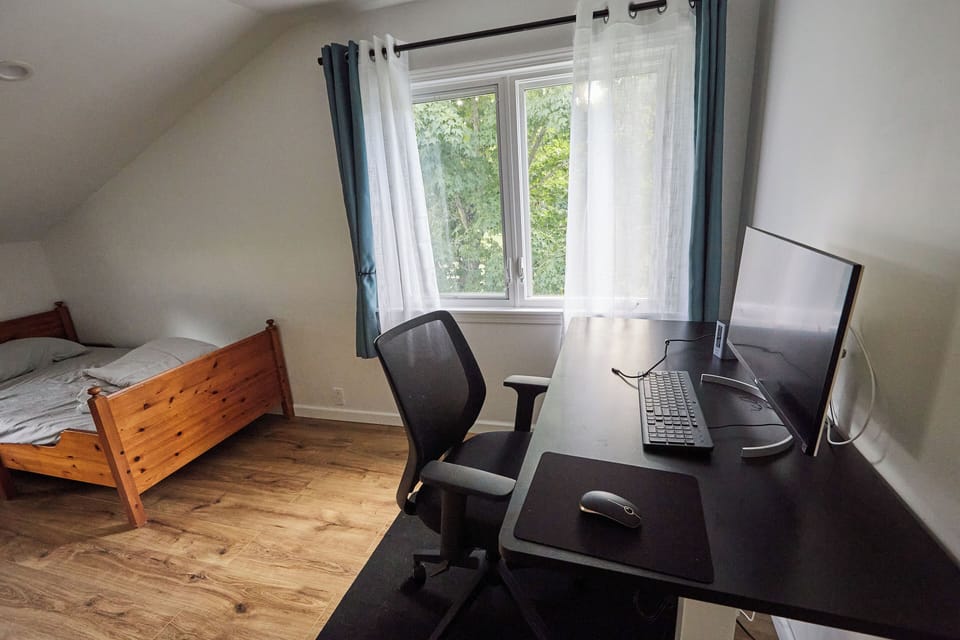 Workspace with desk, chair, monitor, keyboard, mouse and docking station.