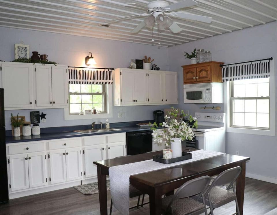 Full size kitchen stocked with your daily kitchen appliances like a refrigerator, microwave, electric stove, and Keurig coffee maker.