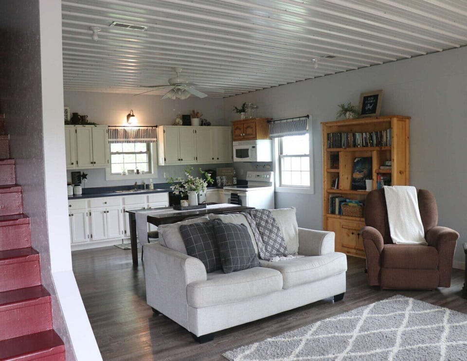 Love seat couch and a lazy boy chair. Prepare your meals in the kitchen and you can still be around the others with the nice open floor space between rooms.