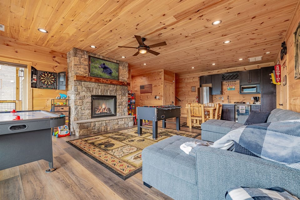 This versatile space is your second living room. It's fully equipped for entertainment and relaxation, featuring a beautiful stone fireplace, a cozy sectional, and a convenient kitchenette for all your needs.