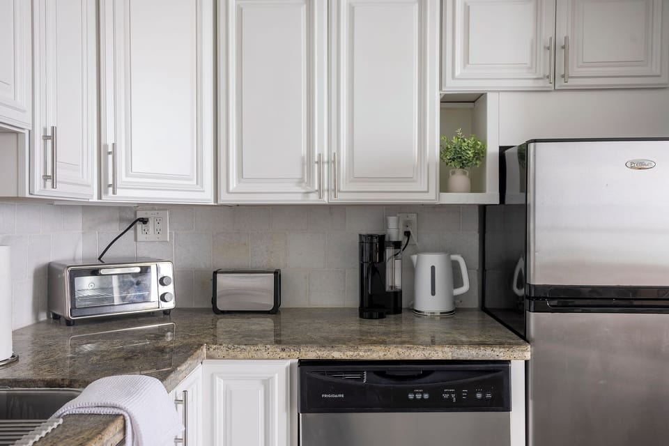 Fully stocked kitchen counter featuring a Keurig coffee maker with coffee pods
