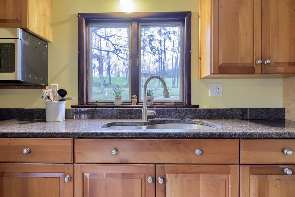 Sink faces towards driveway/road with beautiful scenery.