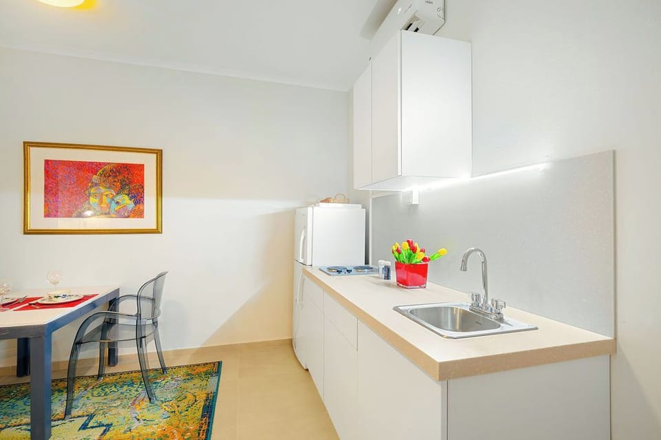 A sleek and efficient kitchenette perfect for your stay! With ample counter space, a stovetop, and a fridge, you have everything you need to prepare your favorite meals.