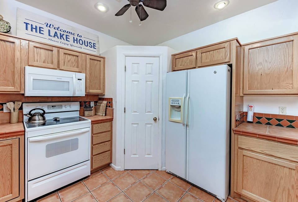 Full kitchen with stove, fridge, microwave, and plenty of cabinet space.