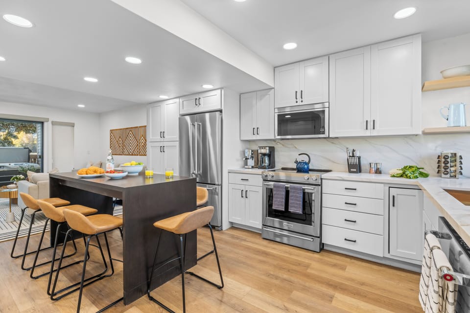 Kitchen and dining area with bar seating and modern finishes.