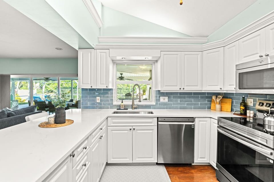 A chef's dream kitchen! 🍳 Prepare your favorite meals in this sparkling, modern space. It is fully stocked with new stainless steel appliances and features bright white cabinetry.