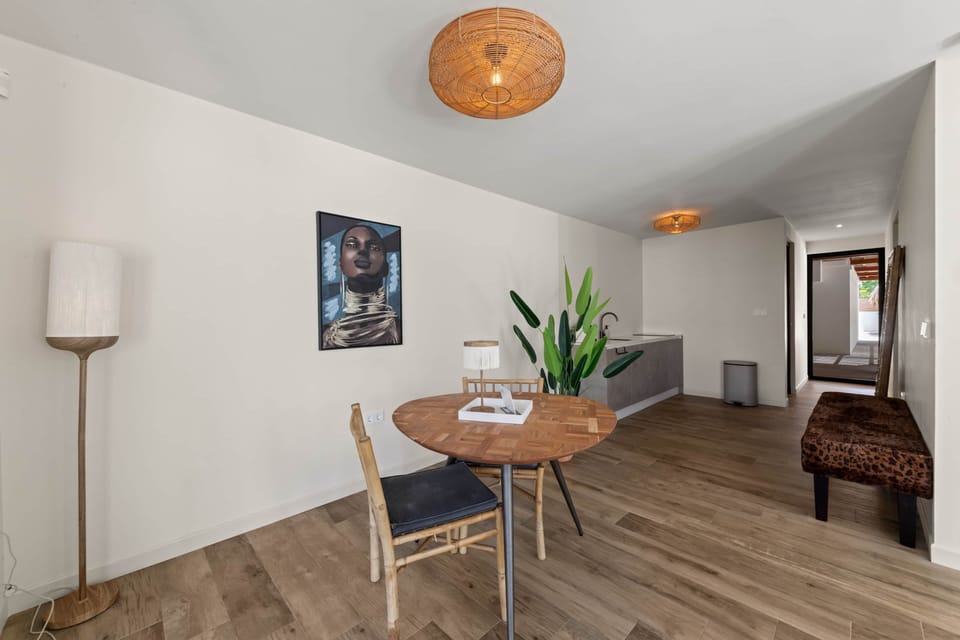 Dining area with view of kitchen & apartment entrance