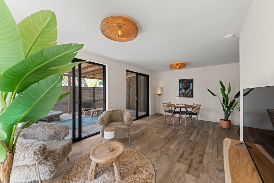 TV room with view of terrace and dining area
