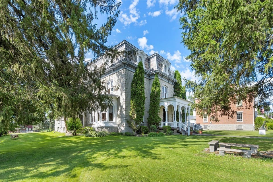 Grand historic estate with sprawling grounds and charming carriage house—perfect for gatherings and getaways.