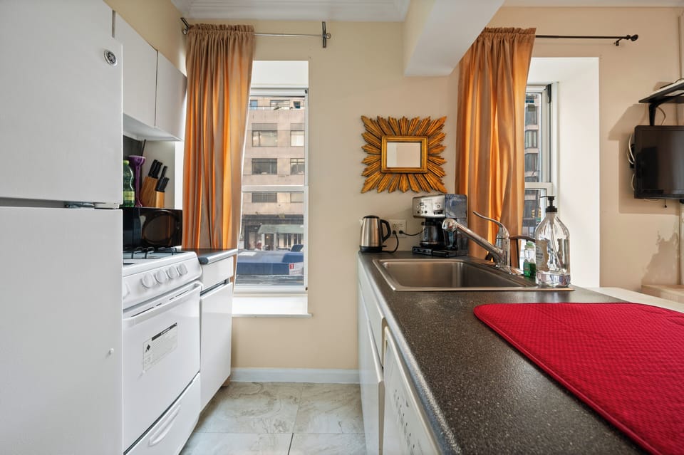Your fully equipped kitchen features modern appliances and city views, perfect for preparing meals during your stay.