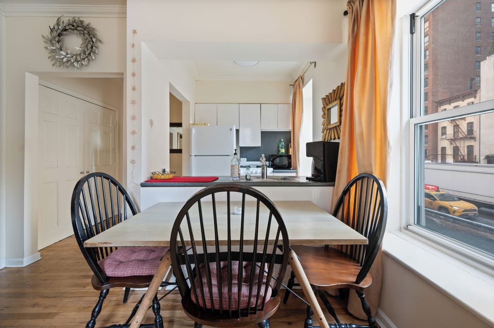 Gather around your spacious dining table for morning coffee or evening meals, with natural light streaming through large windows.