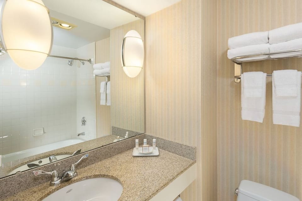Refresh with a bright vanity, fresh towels, and tub shower.