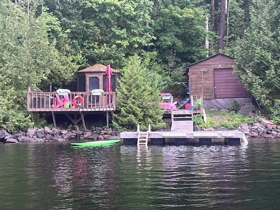 view of dock, boathouse and gazebo from water