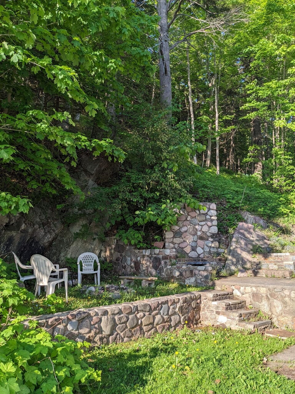 Amazing fire pit surrounded by original stonework, boulders, with lake views 