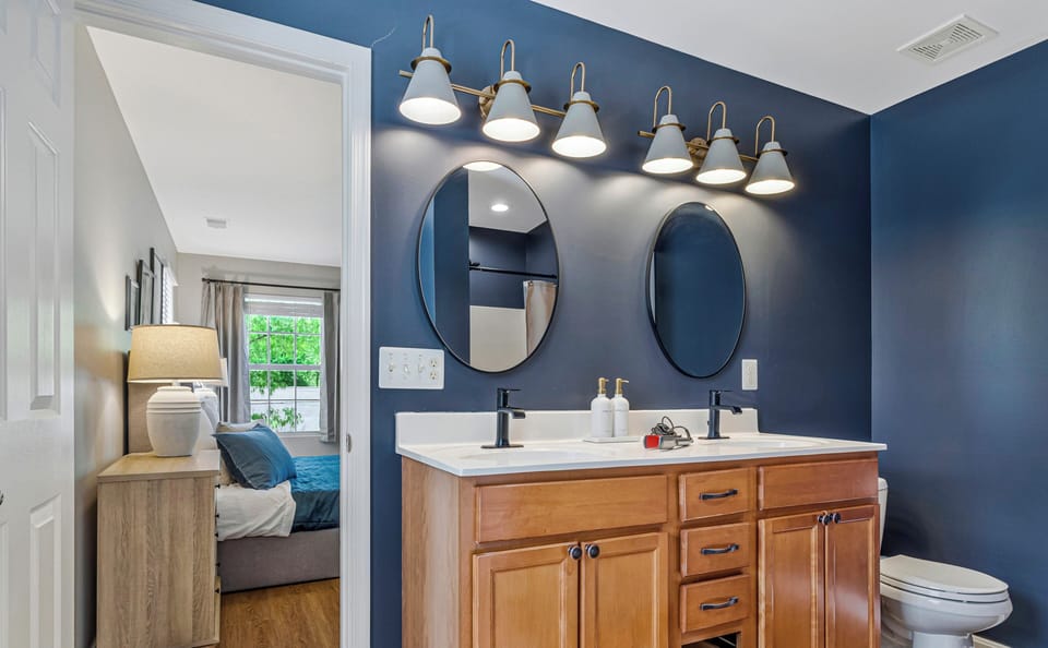 Ensuite bathroom, double‑sink vanity, separate shower next to soaking tub.