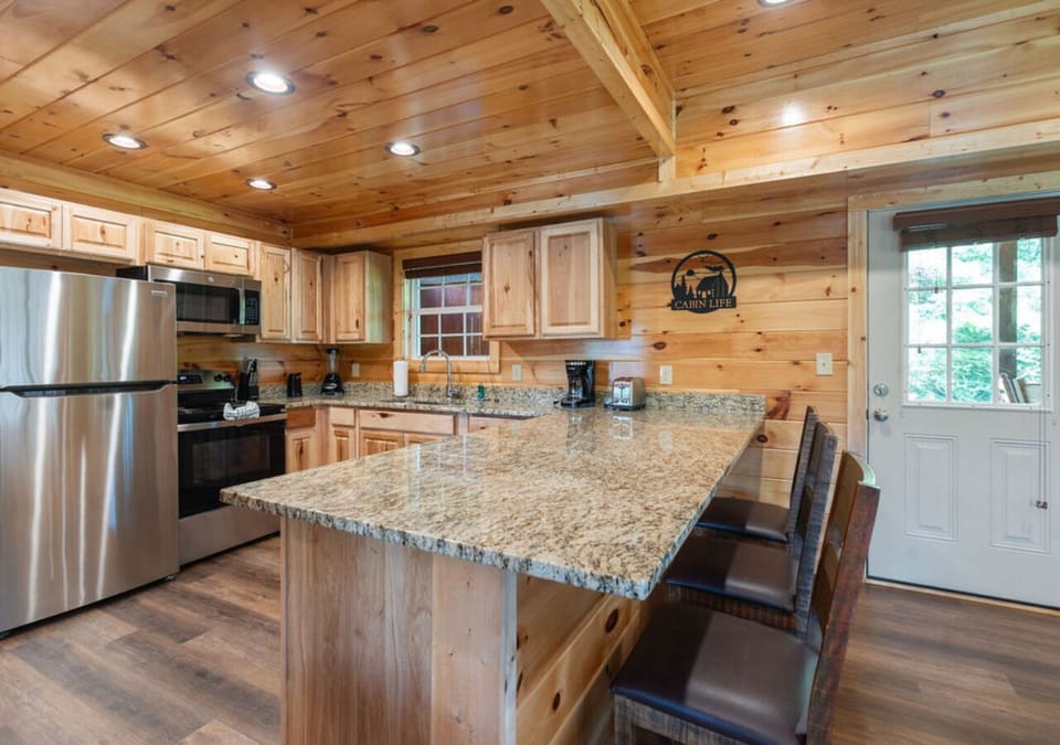Kitchen with stainless steel appliances, granite counters, and ample workspace.