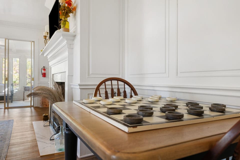 Oversized Checkers Table | Classic Wooden Chairs | Cozy Corner for Family Fun | Perfect for Game Nights