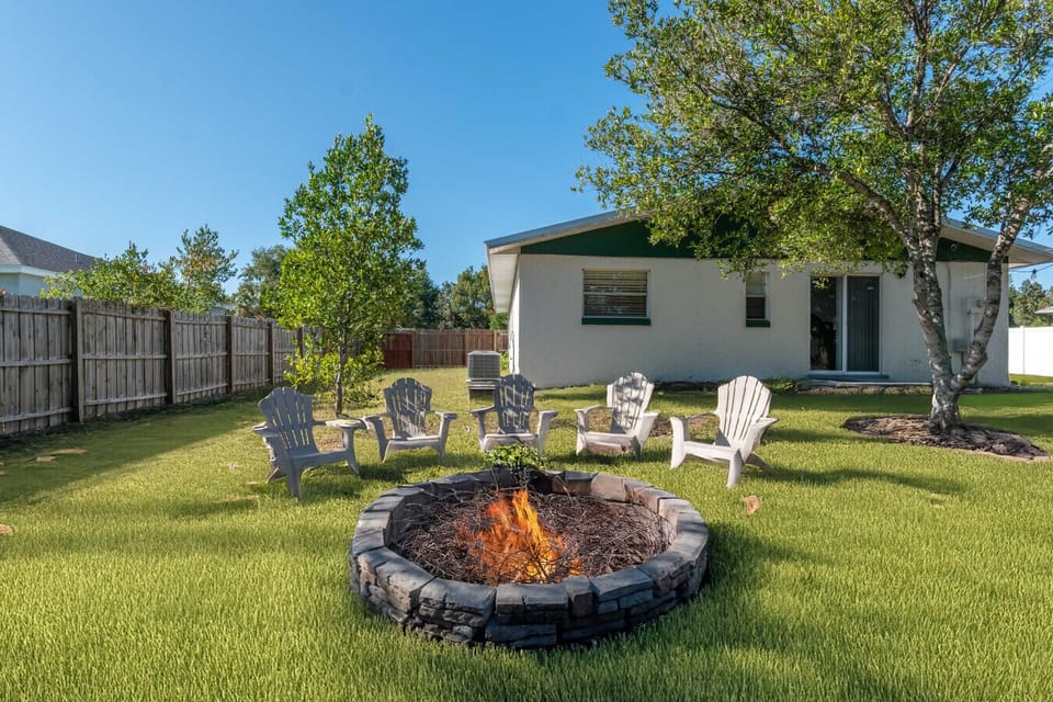 Backyard with Fire Pit | Spacious yard with mature trees, perfect for outdoor gatherings