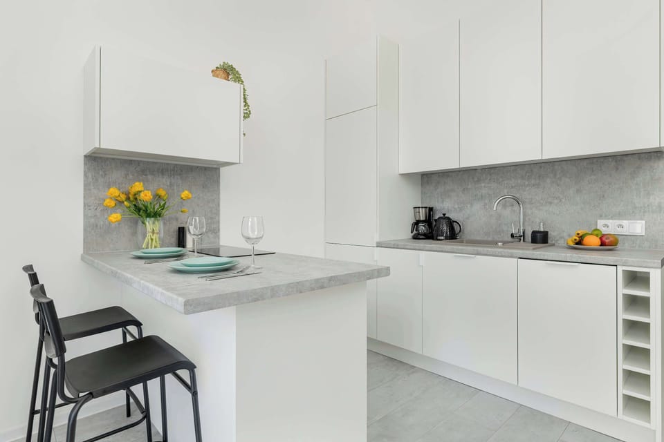 The sleek design of the kitchenette blending seamlessly with the living area.