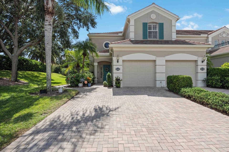 Beautiful paver walkway with greenery and palm trees