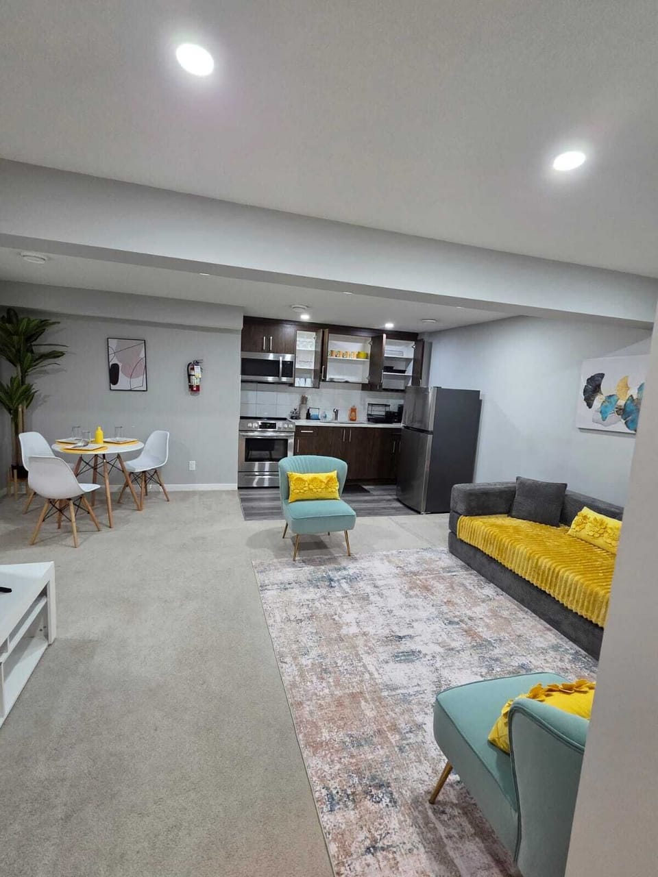 Dark gray sofa bed anchors the living room, paired with a modern coffee table
