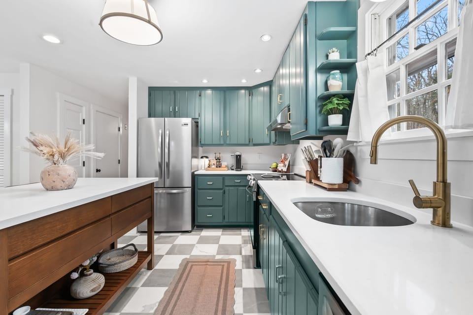 Stylish, updated kitchen with island seating and elegant marble tile floors.