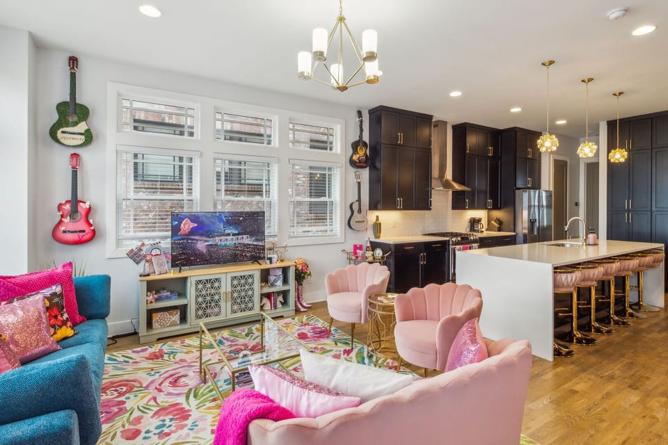 2nd Floor: Taylor Swift themed open-concept living area featuring a Smart TV, stylish furnishings and Taylor Swift decor.