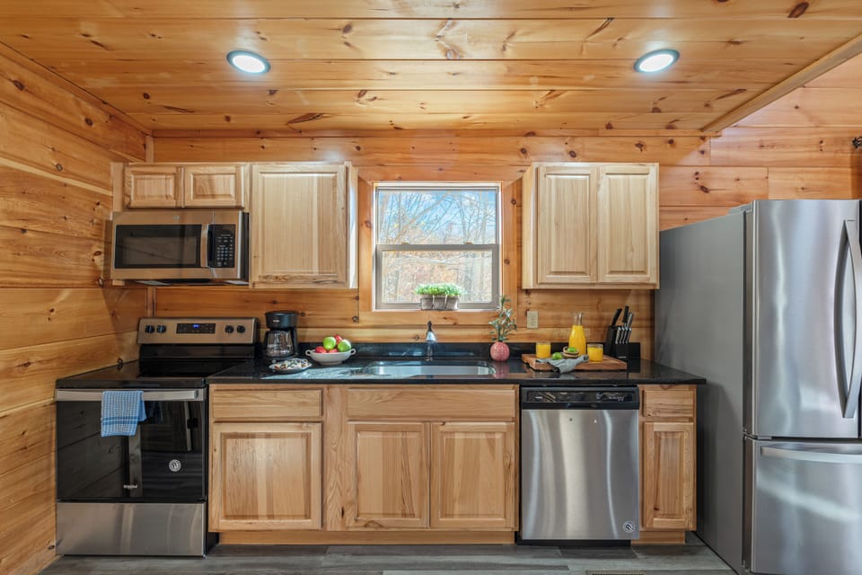 Bright, open kitchen and dining area with modern appliances and mountain views.