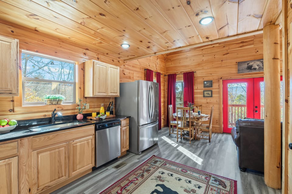 Bright, open kitchen and dining area with modern appliances and mountain views.