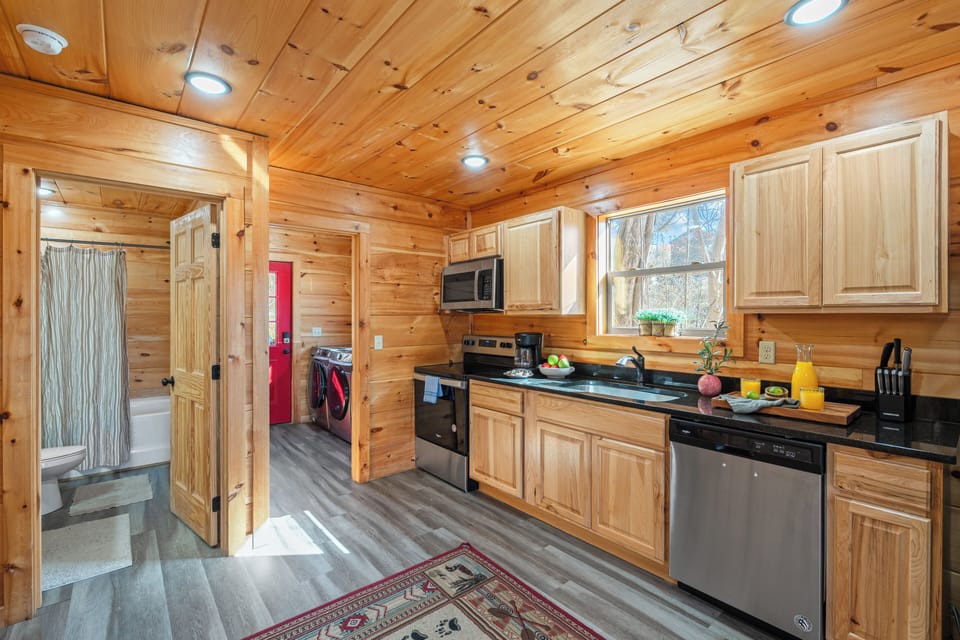 Bright, open kitchen and dining area with modern appliances and mountain views.
