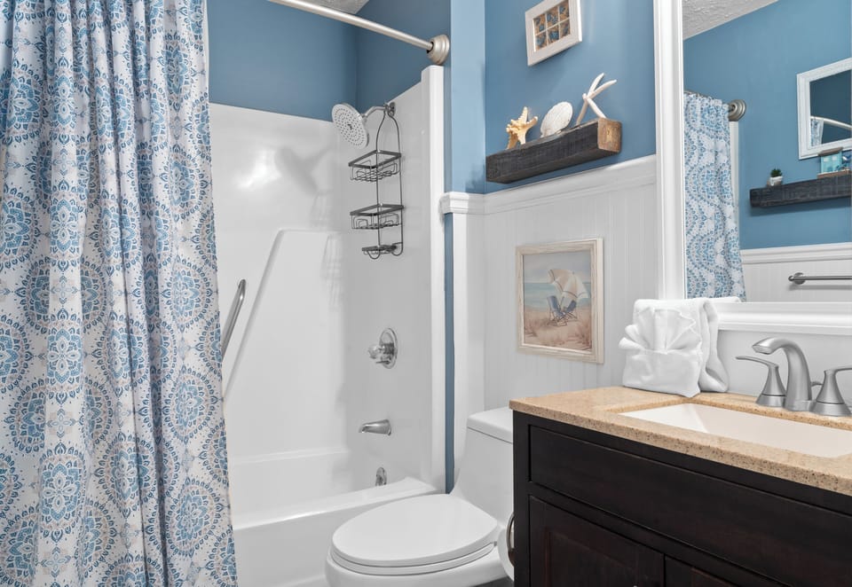 Full bathroom features a shower and tub combo.